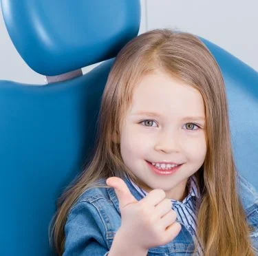 Child smiling in dental chair at Pearly Whites of Pearland, family dentist in Pearland TX.