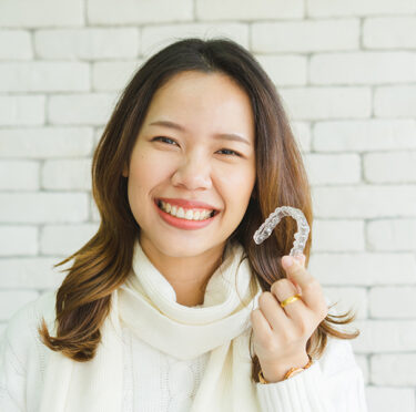 girl showing her invisalign