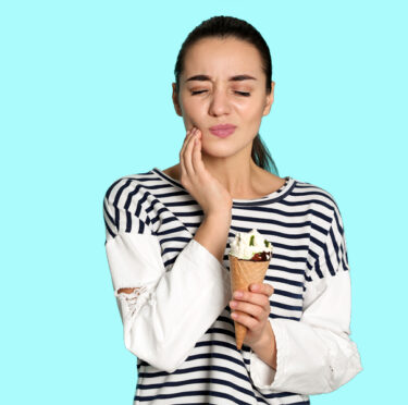 A lady eating ice cream having tooth pain