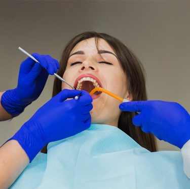 Patient receiving dental care at Pearly Whites of Pearland, a bilingual dental office.